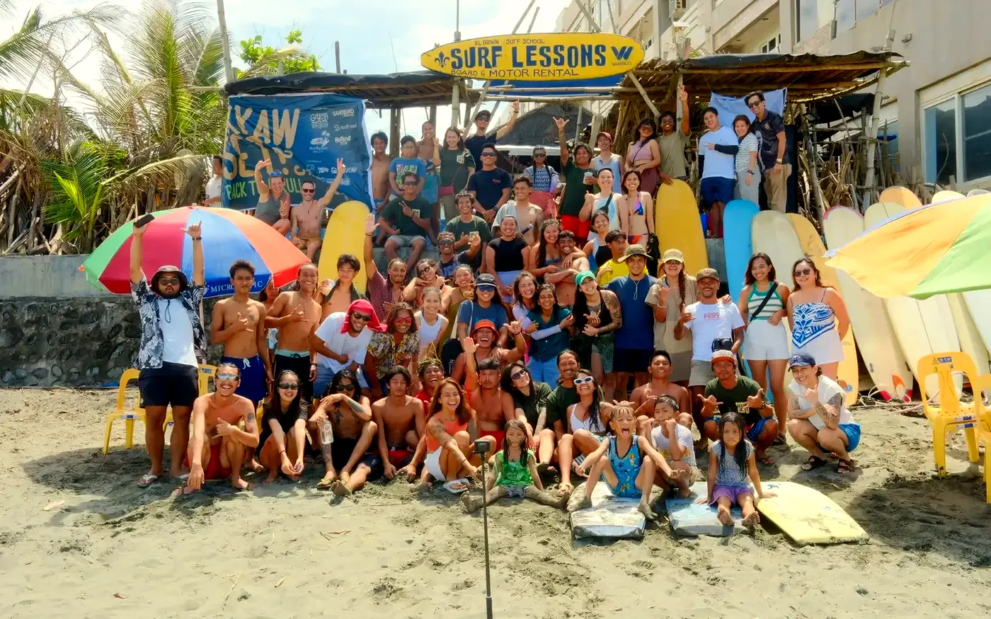 The El Dawn crew, students and friends together under the Surf Lessons sign on Sabang Beach
